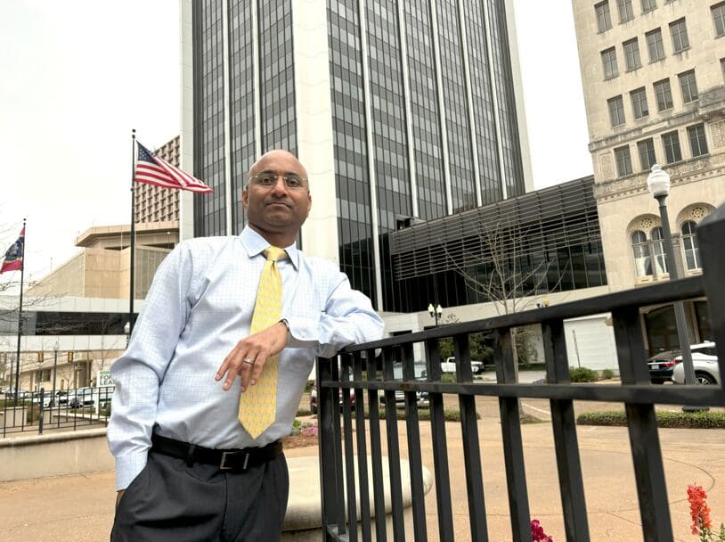 Investor Kumar Bhavanasi stands before the office towers he has acquired in downtown Jackson.